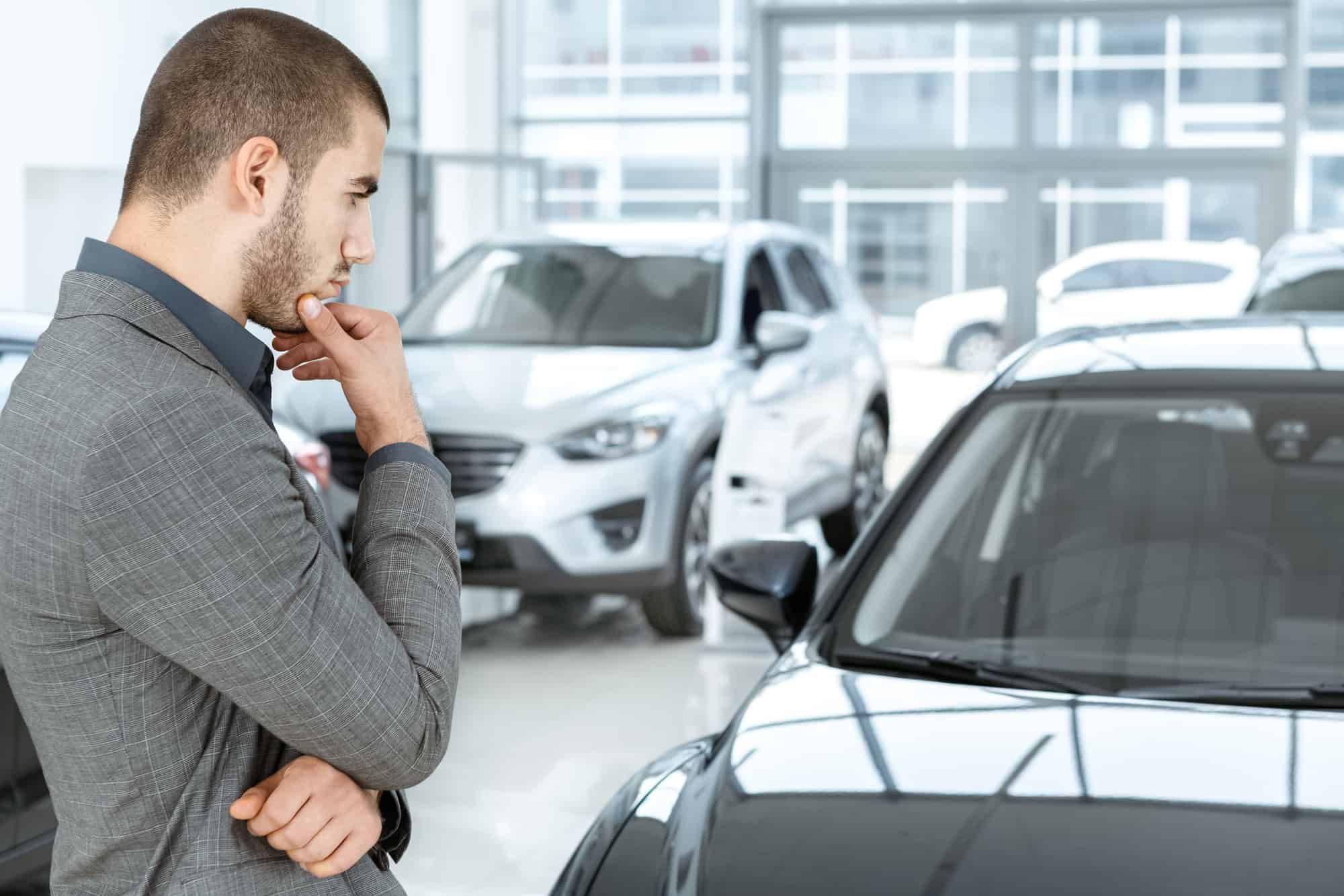 man-looking-at-his-old-car.jpg